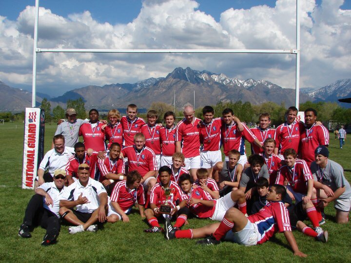 Nick's club rugby team posing together with their trophy and medals after a tournament win